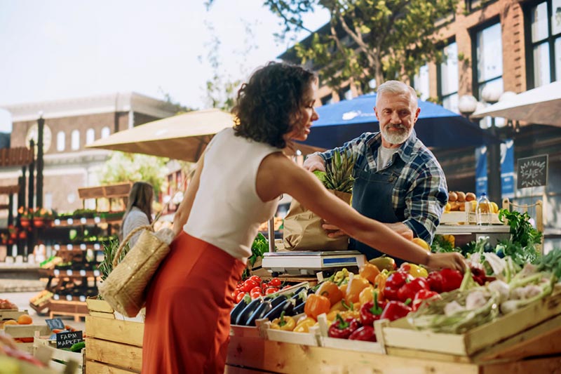 Woman buying groceries at farmer's market